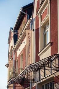 a building with a sign on the side of it at Hotel Kašperk in Kašperské Hory