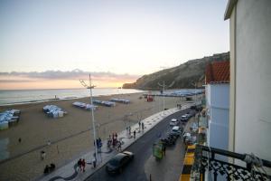 uma vista para a praia a partir de uma varanda de um edifício em Feel Nazaré - Ocean View na Nazaré