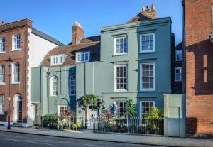 ein grünes Haus auf einer Straße mit Backsteingebäuden in der Unterkunft Ye Spotted Dogge in Portsmouth