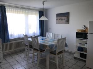 een eettafel en stoelen in een keuken bij Haus Heverstrom in Westerhever