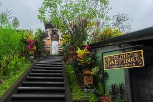 a stairway leading up to a building with a sign at Puri Astina Villa in Ubud