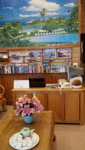 a waiting room with a table with a vase of flowers at Camellia Guest House in Sa Pa