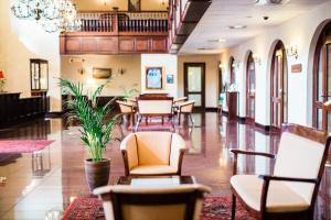 a lobby with chairs and tables in a building at Turówka Hotel & Spa in Wieliczka