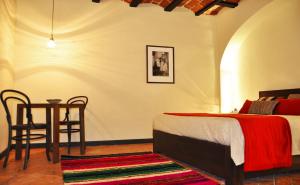 a bedroom with a bed and a table and chairs at Hotel Naira in La Paz