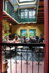 a group of people sitting at tables in a restaurant at Hotel Naira in La Paz