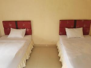 Cama ou camas em um quarto em Rinjani Family Homestay