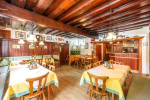 a dining room with two tables and chairs at Hotel & Gasthof Taferne in Schladming