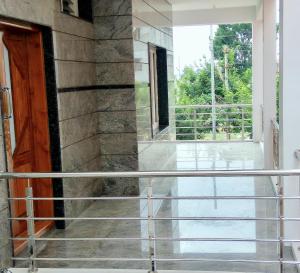 una vista desde la puerta principal de una casa en Aashraya Homestay, en Mysore