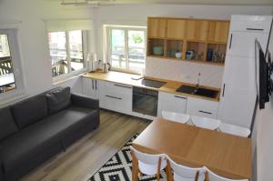 a kitchen with a couch and a table in a room at Kaszubówka 22 in Załakowo