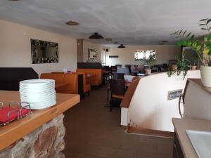 a restaurant with a counter with plates on it at Sunny´s Hotel & Residence in Mainz