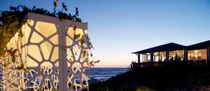 a building on the beach with the ocean in the background at Hotel Oasi Di Kufra in Sabaudia