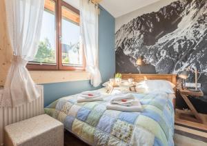 Krevet ili kreveti u jedinici u okviru objekta Apartamenty Rockus LUX & SPA Zakopane