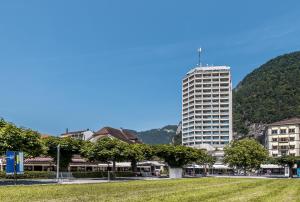 a tall building in the middle of a city at Metropole Swiss Quality Hotel in Interlaken