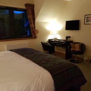 A bed or beds in a room at Kilmichael House