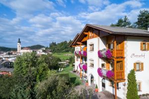 a building with flowers on the side of it at Appartements Plattnerhof in Castelrotto