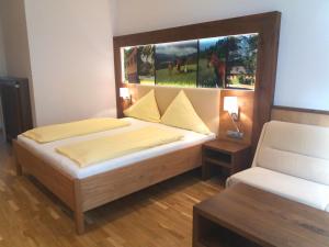 a bedroom with two beds and a window at Gut Drasing in Krumpendorf am Wörthersee