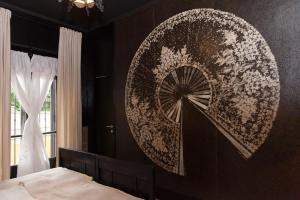 a bedroom with a mandala painting on the wall at Torino Mon Amour in Turin