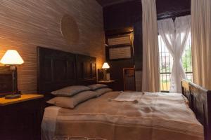 a bedroom with a large bed and a window at Torino Mon Amour in Turin