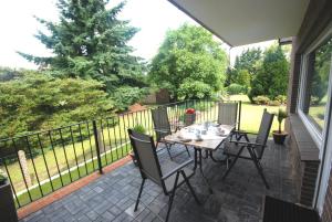 a patio with a table and chairs on a balcony at Gästehaus Spengler in Celle