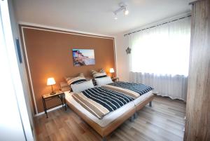 a bedroom with a bed with a large window at Gästehaus Spengler in Celle