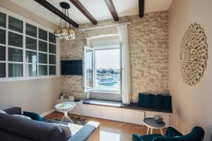 uma sala de estar com uma janela e um sofá em Magic View Apartments em Zadar