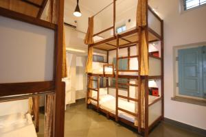 a room with several bunk beds in a room at Jaipur Jantar Hostel in Jaipur