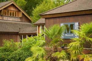 a house with a sign on the side of it at Marwell Hotel - A Bespoke Hotel in Winchester