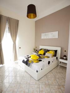 a bedroom with a bed with yellow and black pillows at B&B Feni in Pompei