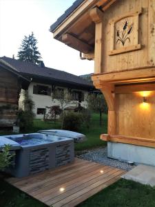 einen Whirlpool auf einer Terrasse neben einem Haus in der Unterkunft Chalet Luxe Les Mélèzes in Samoëns