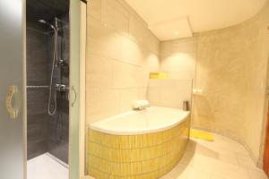 a bathroom with a sink and a shower at La Maison Rapin in Valloire