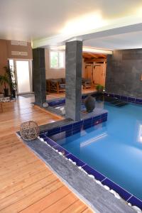 a pool in a building with a swimming pool at La Maison Rapin in Valloire