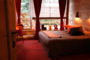 a hotel room with a bed and a window at La Maison Rapin in Valloire