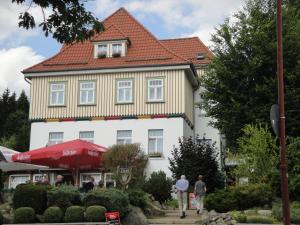 a large white building with a red roof at Garni-Pension Andrä in Schierke