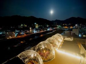 three domes on top of a building at night at Aburaya Tousen in Yamanouchi