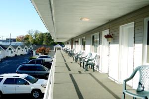 a row of chairs on a porch of a building at adoba® Lockview in Sault Ste. Marie