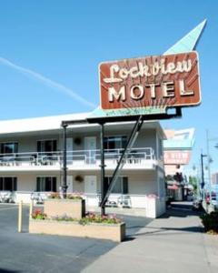 a motel with a sign in front of it at adoba® Lockview in Sault Ste. Marie