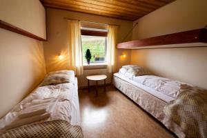 Postel nebo postele na pokoji v ubytování Gjaargardur Guesthouse Gjogv