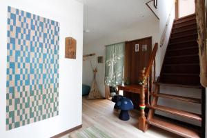 a living room with stairs and a stair case at Midorian in Nikko