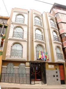 a building with flags on the front of it at UTASA VILLA REAL inn in Puno