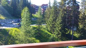 a view of a parking lot with trees at Duplex Le Vogel in Arc 1800