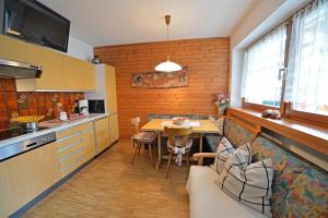 a kitchen with a couch and a table in a room at Apartments Dolomie in Ortisei