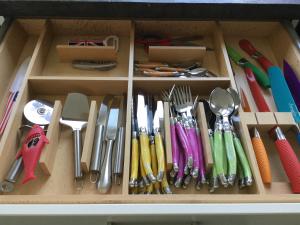 a drawer filled with lots of utensils at chambre d'hôte-abc in Reims