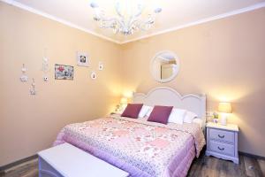 a bedroom with a bed and a chandelier at Shabby chic rooms in Zadar