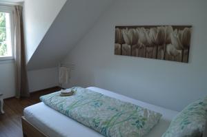 a bedroom with a bed with a pillow on it at BnB zum Schlüssel in Unterehrendingen