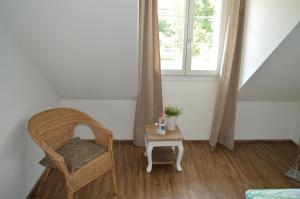 a room with a chair and a table with a window at BnB zum Schlüssel in Unterehrendingen