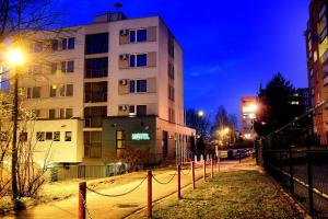 a tall building at night in a city at Afrika Hotel Frýdek-Místek in Frýdek-Místek