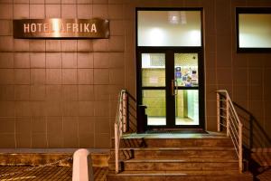 a building with a door and stairs in front at Afrika Hotel Frýdek-Místek in Frýdek-Místek