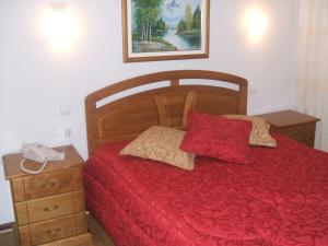 A bed or beds in a room at Residencial Pinto