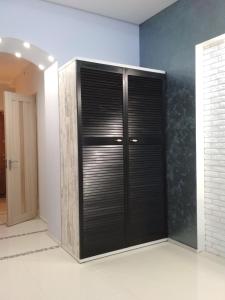 a room with black doors and a wall at Apartment on Tytova 8 in Dnipro