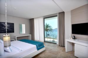 Cama ou camas em um quarto em Lugga Boutique Hotel & Beach